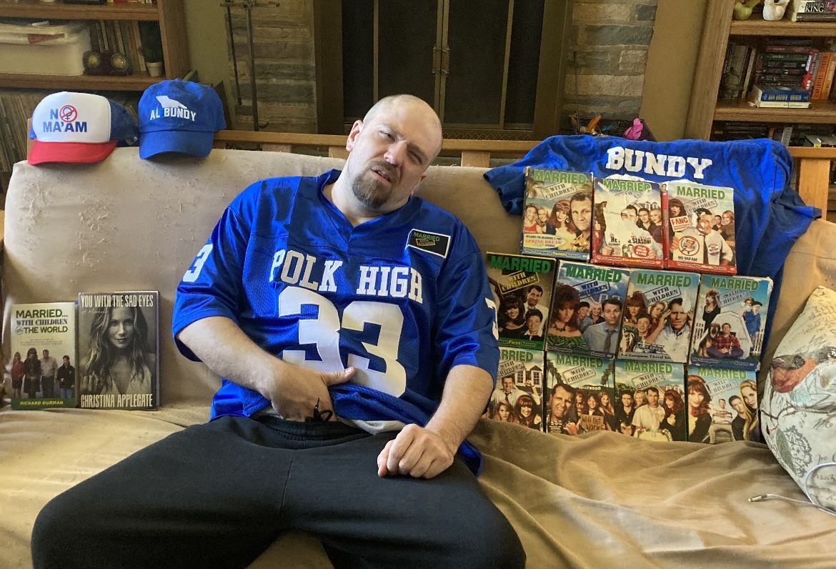 Married with Children fan on couch polk high jersey